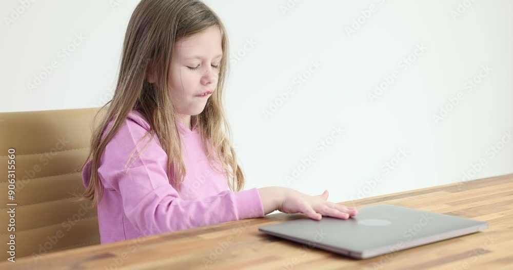 Junior schoolgirl closes laptop leaning back in chair at home. Child feels sense of accomplishment and relief from completing home tasks Junior schoolgirl closes laptop leaning back in chair at home. Child feels sense of accomplishment and relief from completing home tasks