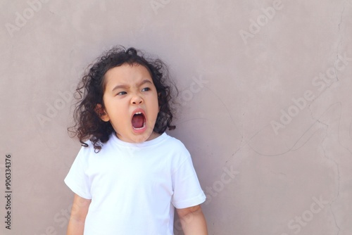Portrait of a girl who is yawning because she is sleepy.