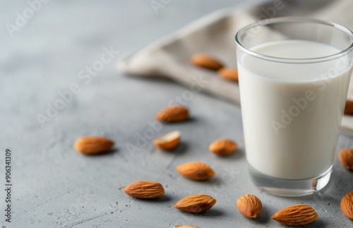 Freshly Made Almond Milk With Raw Almonds on a White Surface photo