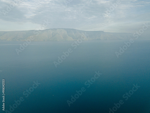 Aerial drone view of Toba Lake with blue water at Pangururan in Samosir Island, Sumatra Utara, Indonesia