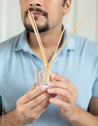 Man holds scented aromatic reed diffuser sticks set photo