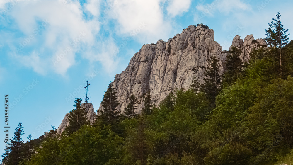 Alpine summer evening view with a summit cross at Mount Kampenwand, Aschau, Chiemgau, Rosenheim, Bavaria, Germany Alpine summer evening view with a summit cross at Mount Kampenwand, Aschau, Chiemgau, Rosenheim, Bavaria, Germany