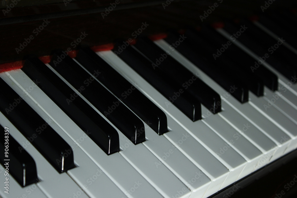 Close-up image of a piano keyboard showing black and white keys, emphasizing the musical instrument's details and textures. Close-up image of a piano keyboard showing black and white keys, emphasizing the musical instrument's details and textures.