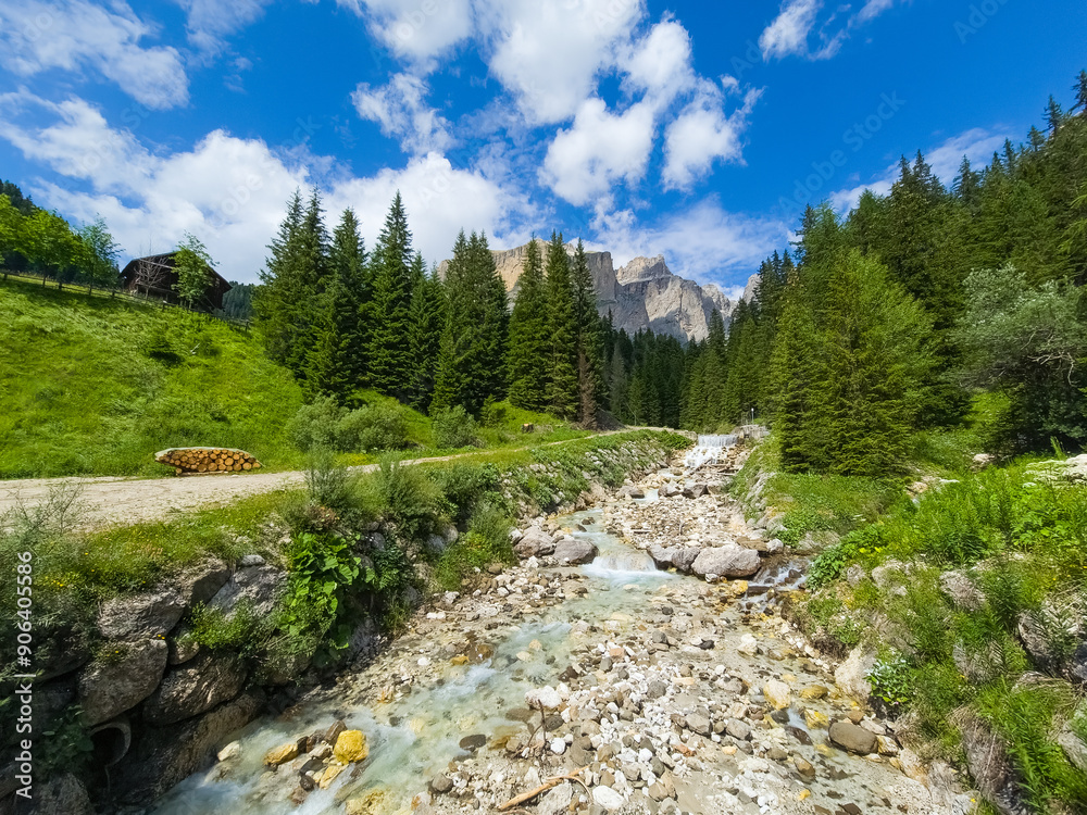 Photo of a stream in Val di Fassa with Sass Pordoi in the background - Italy Photo of a stream in Val di Fassa with Sass Pordoi in the background - Italy