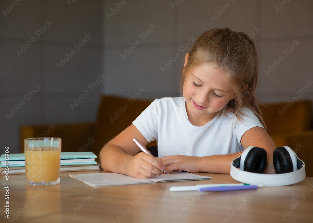 Cute little girl doing homework at home. education concept.Back to school Cute little girl doing homework at home. education concept.Back to school