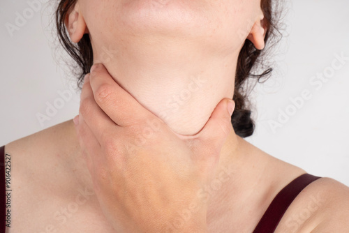 woman holding her throat, sore throat.