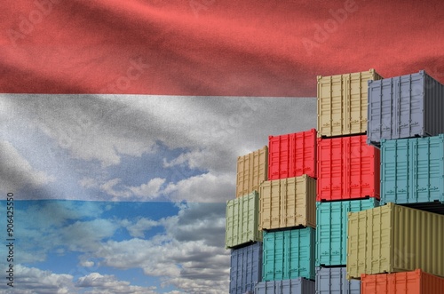 Luxembourg flag and big stack of shipping cargo containers in docks with sky background close up photo