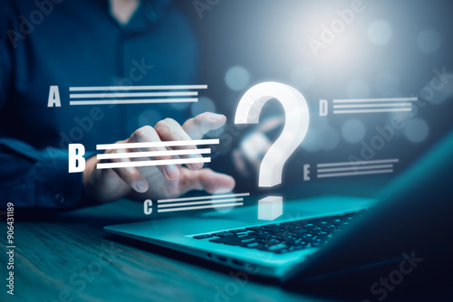 Ask question online concept, Businessman hand hold interface question marks sign web, Question marks drawn on black background. Concept of searching for an answer, Uncertainty and problem solving. photo