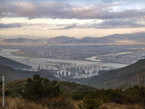 High angle and autumnal view of apartments and Nakdong River seen from Geumjeongsan Mountain of Hwamyeong-dong near Buk-gu, Busan, South Korea
 photo