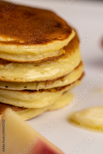 milk pancakes with butter and sliced peach slices