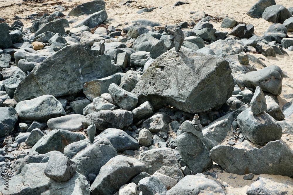 Balanced stones on rocks on a sunny Cornish beach. Balanced stones on rocks on a sunny Cornish beach.