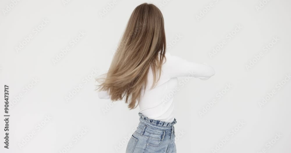 Young woman performs warming up exercise rotating upper body against white wall. Female tries to cope with pain in back in office slow motion