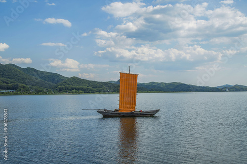 Yangsu-ri, Yangpyeong-gun, Gyeonggi-do, South Korea - June 4, 2017: Summer view of a yellow-bellied sailboat moored on Paldang Lake and Namhan River
 photo