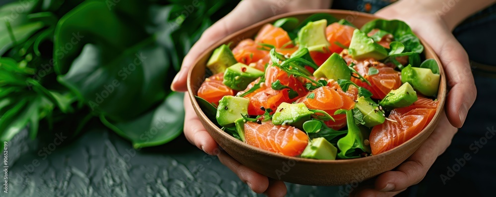Fresh salad with salmon and avocado, served in a wooden bowl, perfect for healthy eating and vibrant meals. Fresh salad with salmon and avocado, served in a wooden bowl, perfect for healthy eating and vibrant meals.