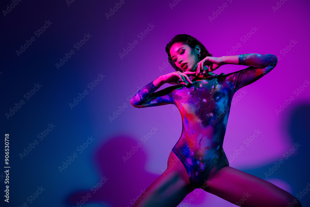 Photo of carefree seductive woman dressed print bodysuit strip dancing empty space isolated violet color background Photo of carefree seductive woman dressed print bodysuit strip dancing empty space isolated violet color background