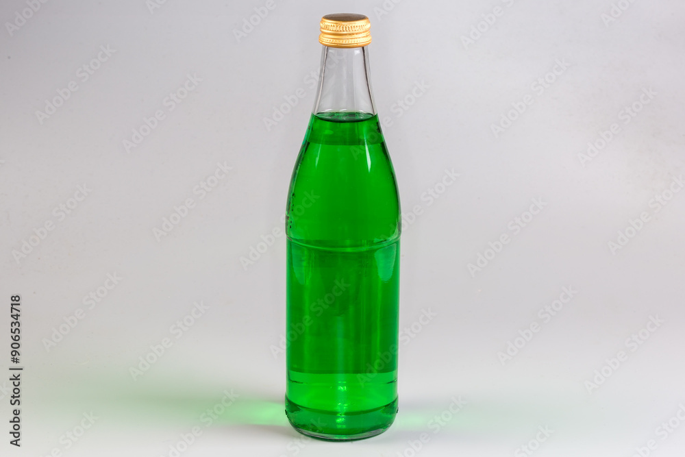 Green non-alcoholic carbonated drink in the closed glass bottle Green non-alcoholic carbonated drink in the closed glass bottle