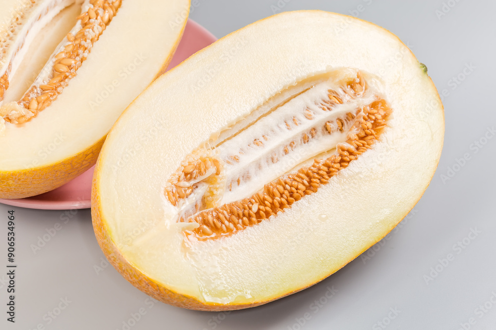 Two halves of yellow melon with seeds, close-up Two halves of yellow melon with seeds, close-up