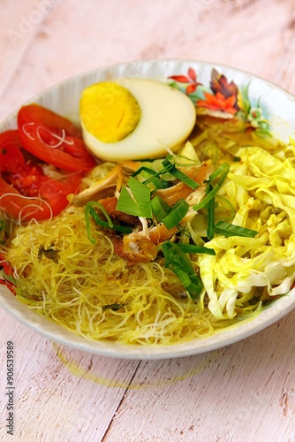 Chicken soup or Chicken Soto or Soto Ayam in Indonesia. Soto ayam is a traditional Indonesian dish which uses ingredients such as chicken, vermicelli, bean sprout with turmeric photo