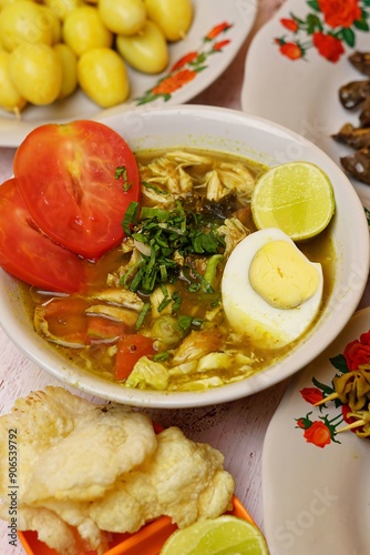 Chicken soup or Chicken Soto or Soto Ayam in Indonesia. Soto ayam is a traditional Indonesian dish which uses ingredients such as chicken, vermicelli, bean sprout with turmeric photo