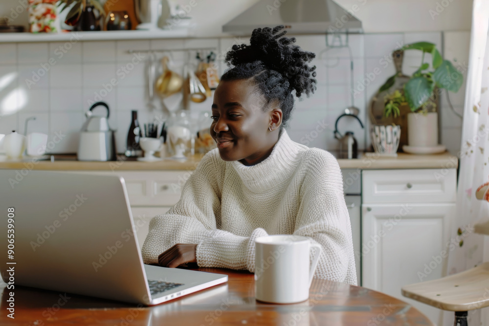 A woman in a white sweater, seated at her kitchen table with a mug, enjoys working on her laptop in a bright, airy setting. A woman in a white sweater, seated at her kitchen table with a mug, enjoys working on her laptop in a bright, airy setting.