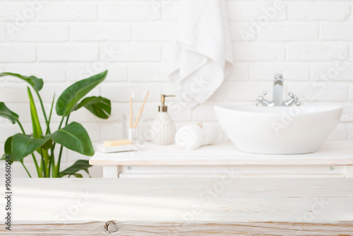 Blurred bathroom interior background with empty wooden table top for product montage