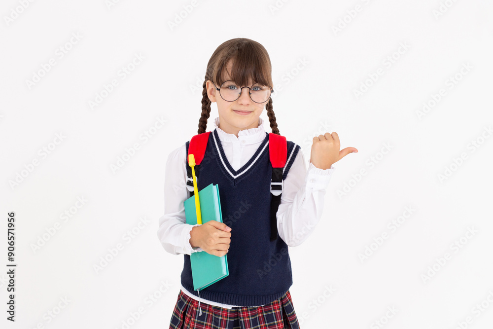 An engaged teen girl looks excited, pointing right, with notebook and yellow pen getting an idea, isolated on white An engaged teen girl looks excited, pointing right, with notebook and yellow pen getting an idea, isolated on white