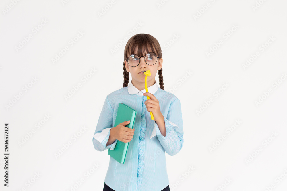 Cute girl thinking what to write in notepad. Young student girl is thoughtful with pencil in hand on white background Cute girl thinking what to write in notepad. Young student girl is thoughtful with pencil in hand on white background
