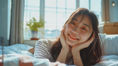 A Young Woman Resting on a Bed with a Soft Smile Free Download A Young Woman Resting on a Bed with a Soft Smile - GFXLoad