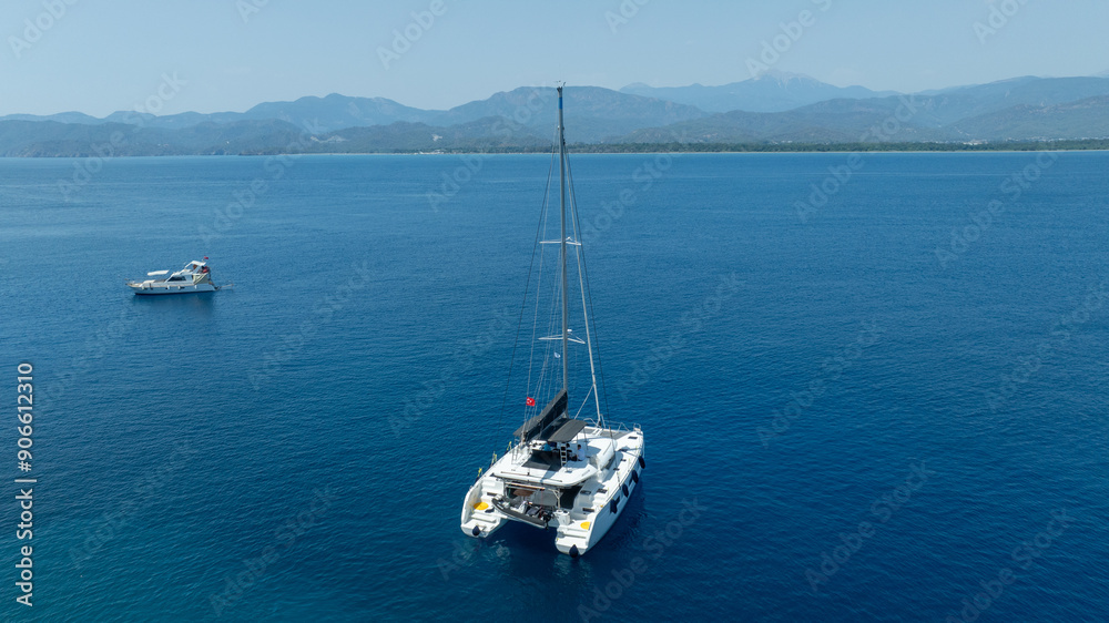 The beauty of a catamaran cruising, seen from above. The beauty of a catamaran cruising, seen from above.