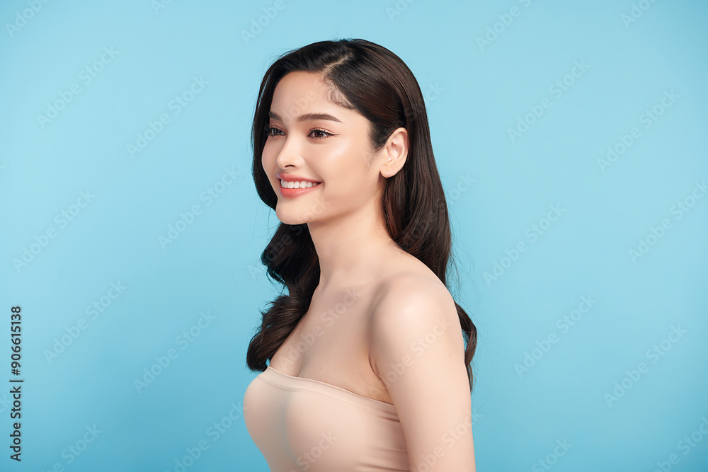 Obraz premium Beautiful Young transgender woman with clean fresh skin on blue background, Face care, Facial treatment, Cosmetology, beauty and spa, transgender women portrait.