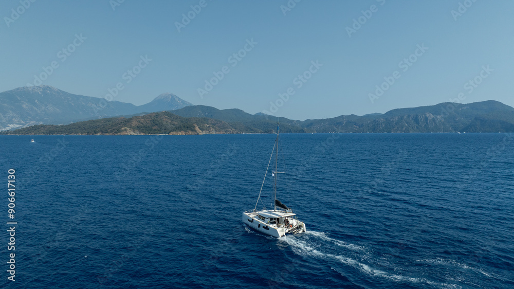 catamaran sailing gracefully, captured by a drone. catamaran sailing gracefully, captured by a drone.