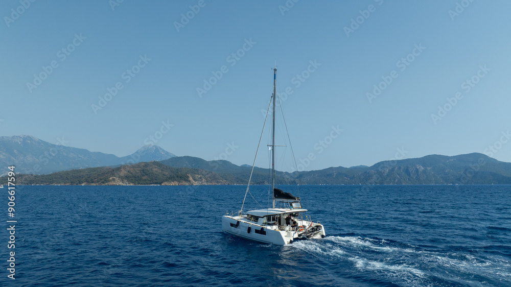 catamaran sailing gracefully, captured by a drone. catamaran sailing gracefully, captured by a drone.