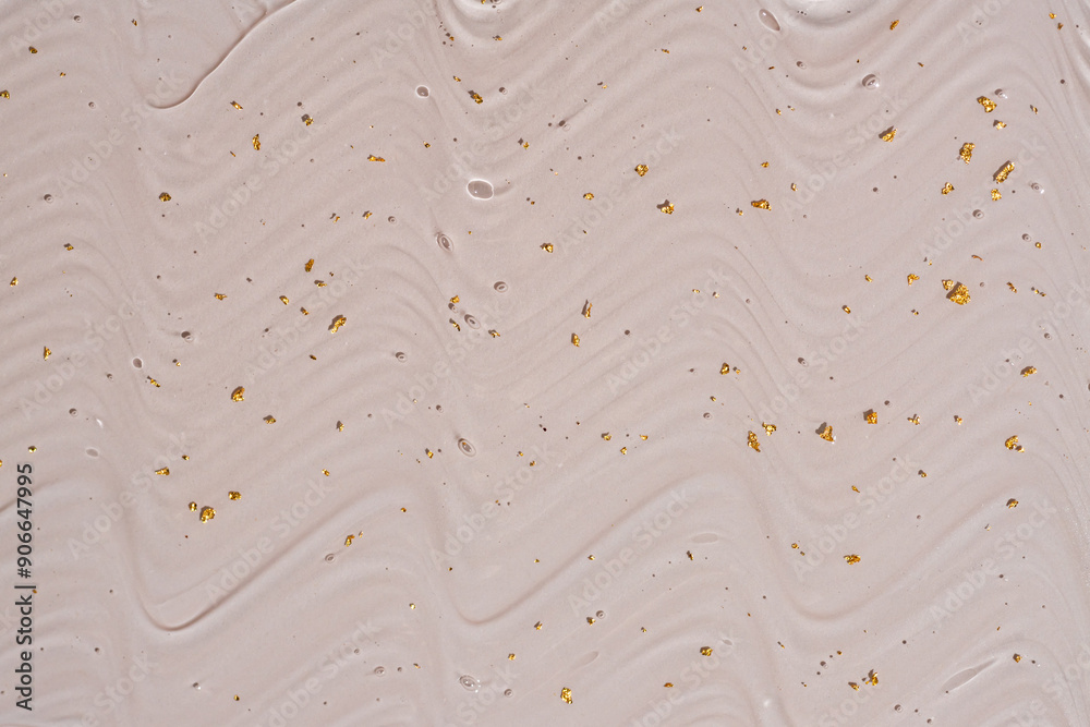 Obraz premium Liquid gel abstract cosmetic background. Smear of transparent moisturizing product with golden particles on beige background
