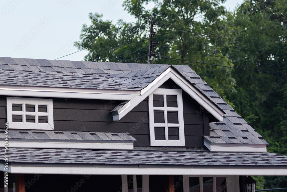 roof shingle with fake garret window with tree as background. house roof. concept : buy or rent house resident. roof shingle with fake garret window with tree as background. house roof. concept : buy or rent house resident.