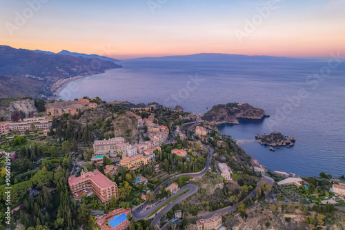 Aerial view of the Ancient theater of Taormina with Mount Etna in the background, Sicily, Italy. Isola Bella island