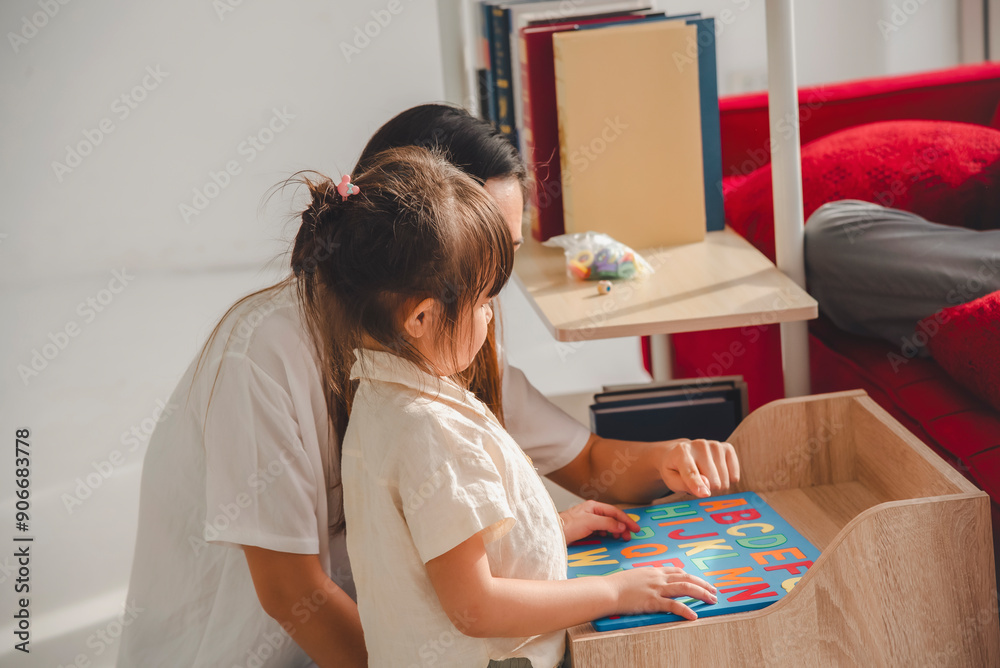 A parent and child engaging in a playful educational activity with a colorful book in a cozy home setting. A parent and child engaging in a playful educational activity with a colorful book in a cozy home setting.