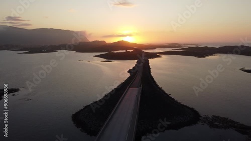 Aerial drone view of cars driving on bridge during midnight sun photo