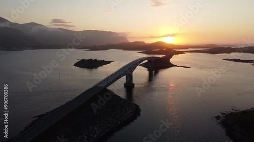 Aerial drone view of cars driving on bridge during midnight sun photo