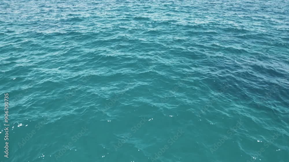Aerial view of a blue sea water background. Aerial flying drone view. Waves water surface. Flight over the ocean. Aerial ocean view. Top fly over the sea. The camera changes angle upwards over the sea Aerial view of a blue sea water background. Aerial flying drone view. Waves water surface. Flight over the ocean. Aerial ocean view. Top fly over the sea. The camera changes angle upwards over the sea