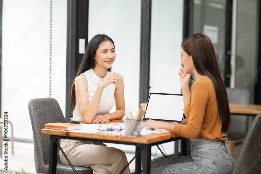 Asian business woman Discussing business documents in the office
Asian business woman Discussing business documents in the office
