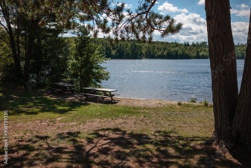 Nichols Lake Picnic Area near Boulder Junction, Wisconsin in early September, with a blue sky and billowing white clouds photo