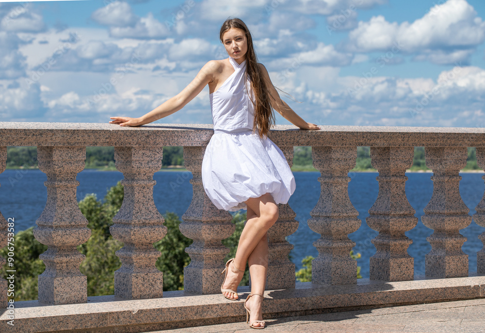Portrait of a young beautiful blonde woman in a white dress Portrait of a young beautiful blonde woman in a white dress