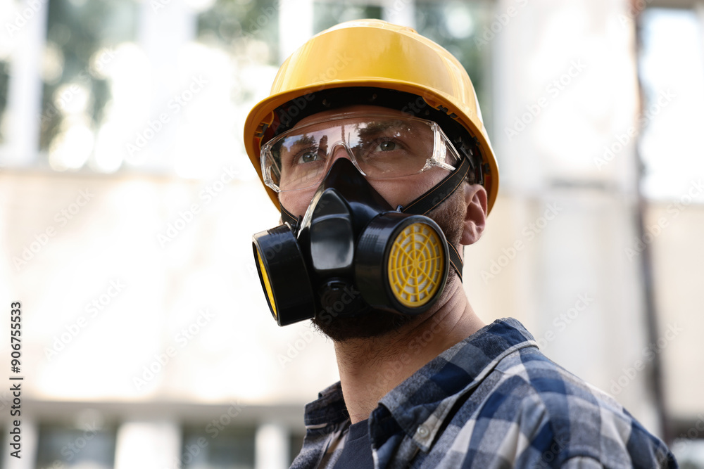 Man in respirator mask and hard hat outdoors. Safety equipment Man in respirator mask and hard hat outdoors. Safety equipment