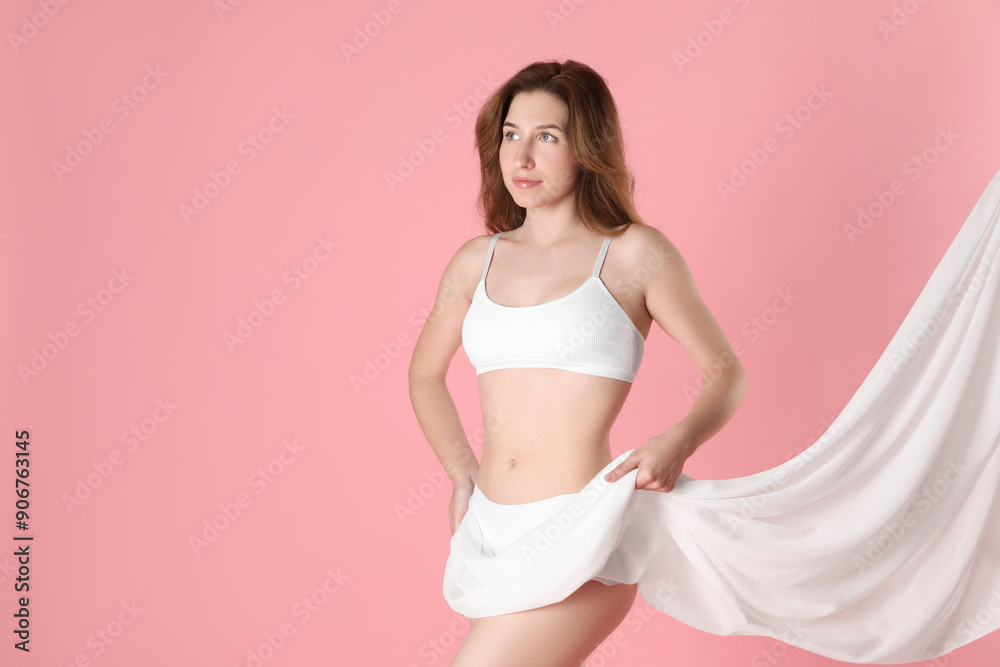 Fototapeta premium Woman covering her slim body with silk fabric against pink background, space for text