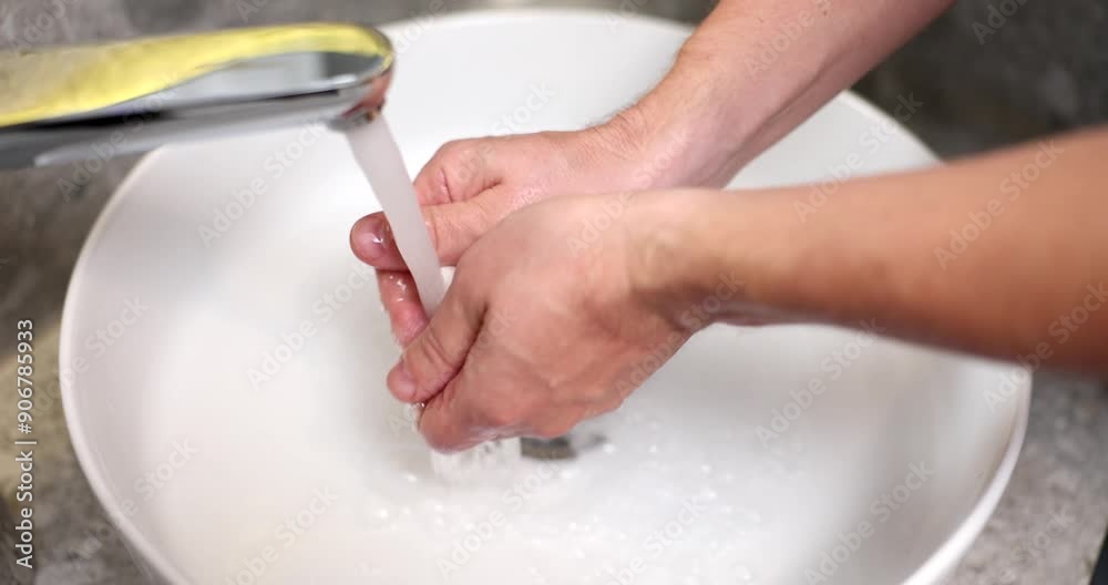Man washing his hands with soap in bathroom sink closeup 4k movie slow motion. Hand hygiene concept Man washing his hands with soap in bathroom sink closeup 4k movie slow motion. Hand hygiene concept