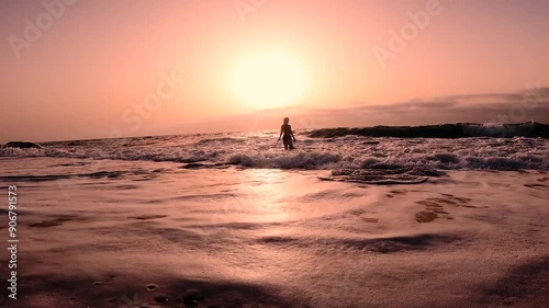 One woman take a bath at the beach dunring sunset.  photo