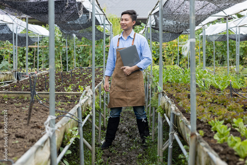 Wallpaper Mural Farmer Using Laptop in Greenhouse for Crop Monitoring Torontodigital.ca