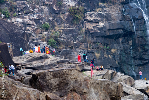 Local tribal women gather near the 322 feet Hundru waterfall to feast Shiva, the Supreme being in Hindu Shaivism, and beseech health and strength for their menfolk, Ranchi, Jharkhand, India, Asia photo