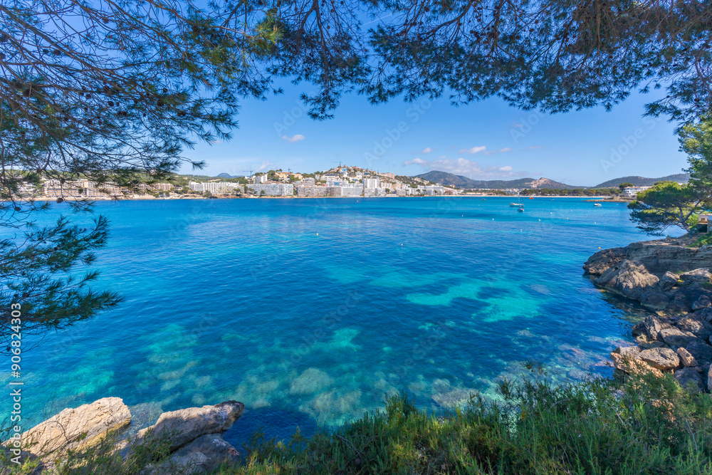 View of rocky shoreline by turquoise sea and Santa Ponsa, Majorca, Balearic Islands, Spain, Mediterranean, Europe View of rocky shoreline by turquoise sea and Santa Ponsa, Majorca, Balearic Islands, Spain, Mediterranean, Europe