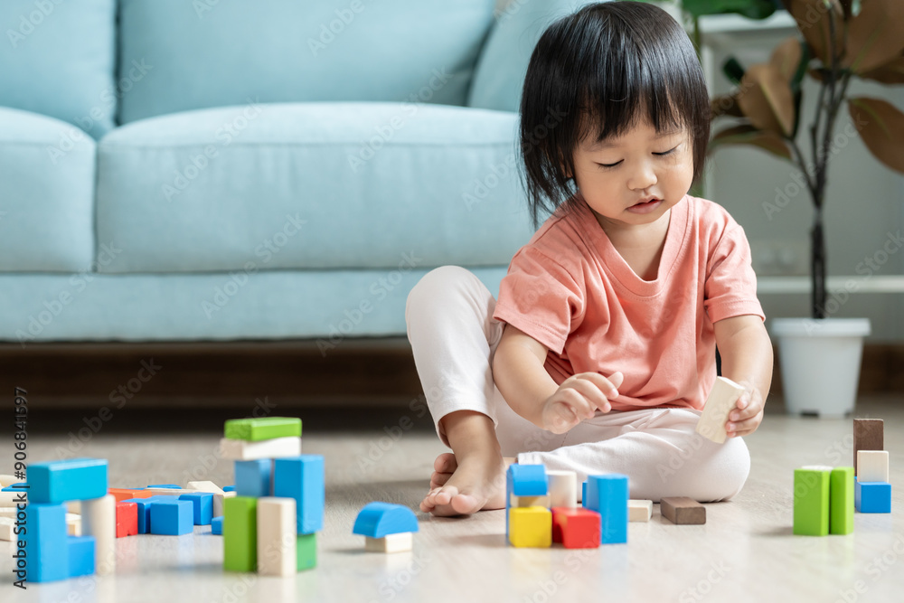 Happy Asian child playing and learning toy blocks. children are very happy and excited at home. child have a great time playing, activities, development, attention deficit hyperactivity disorder Happy Asian child playing and learning toy blocks. children are very happy and excited at home. child have a great time playing, activities, development, attention deficit hyperactivity disorder